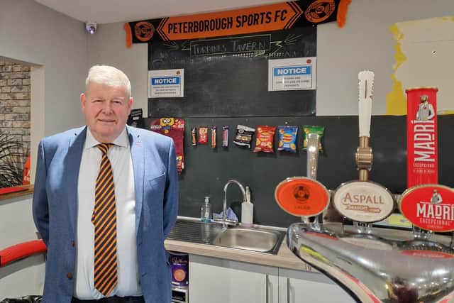 Club chairman Tim Woodward behind the bar where much of the damage was caused