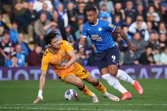 Jonson Clarke-Harris of Peterborough United takes on Zeno Ibsen Rossi of Cambridge United. Photo: Joe Dent/theposh.com.