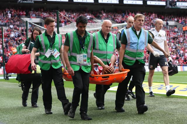 Nathan Thompson is carried off injured after 5 minutes of the 2015 League One play-off final at Wembley. Photo by Carl Court/Getty Images.