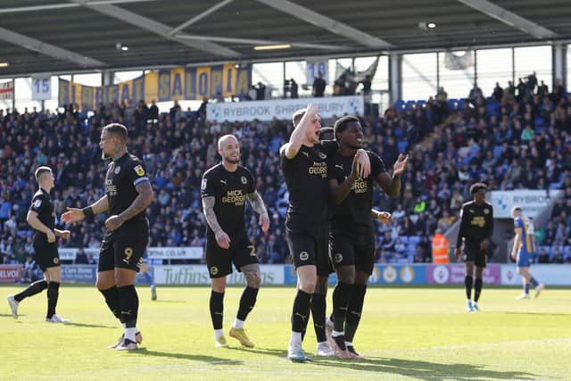 Posh players celebrate Ephron Mason-Clark's goal at Shrewsbury. Photo: Joe Dent/theposh.com.