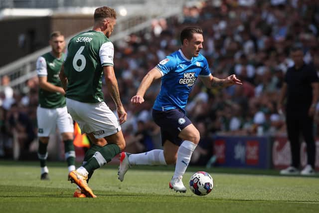 Ben Thompson of Peterborough United is closed down by  Dan Scarr of Plymouth Argyle. Photo: Joe Dent/theposh.com