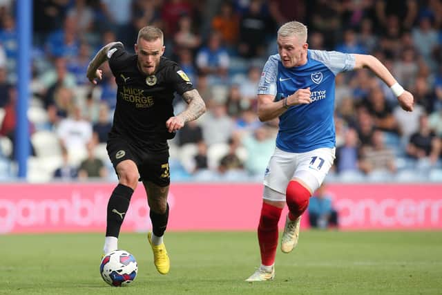Joe Ward of Posh in action with Ronan Curtis of Portsmouth. Joe Dent/theposh.com