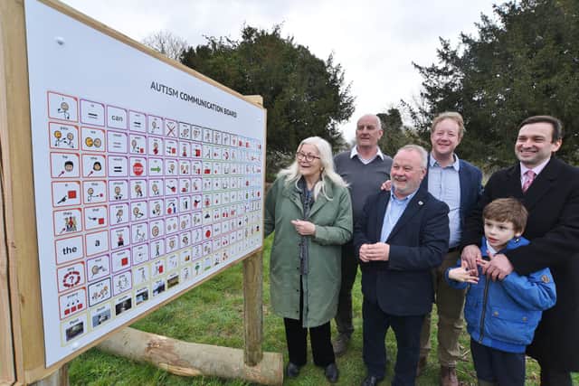 New autism communication board installed at Holywell Ponds, Longthorpe. Daniel Harris and his son with  MP for Peterborough Paul Bristow and city councillors Wayne Fitzgerald, Nigel Simons and Lynne Ayres