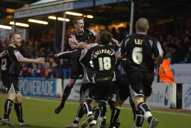 Posh celebrate a goal at Colchester in the FA Cup in 2008. Photo: David Lowndes.