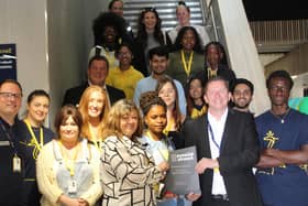 ARU Peterborough principal Ross Renton with students and staff with the award at University House