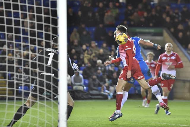 Jonson Clarke-Harris (hidden) scores the first goal for Posh against Barnsley. Photo: David Lowndes.