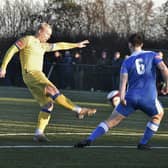 Lewis Hilliard (yellow) in action for Spalding United.