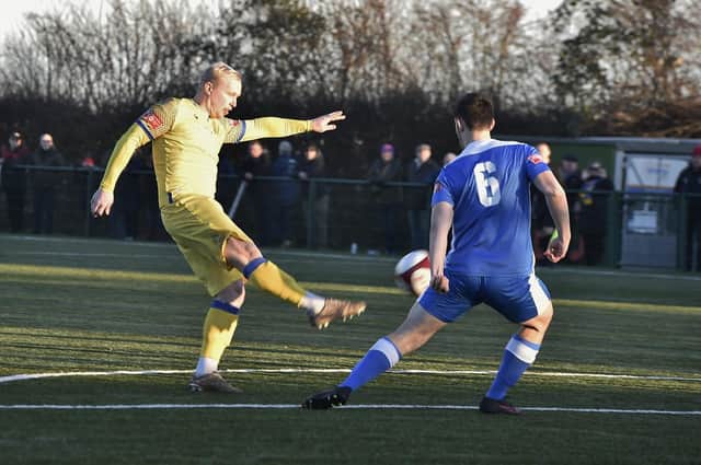 Lewis Hilliard (yellow) in action for Spalding United.