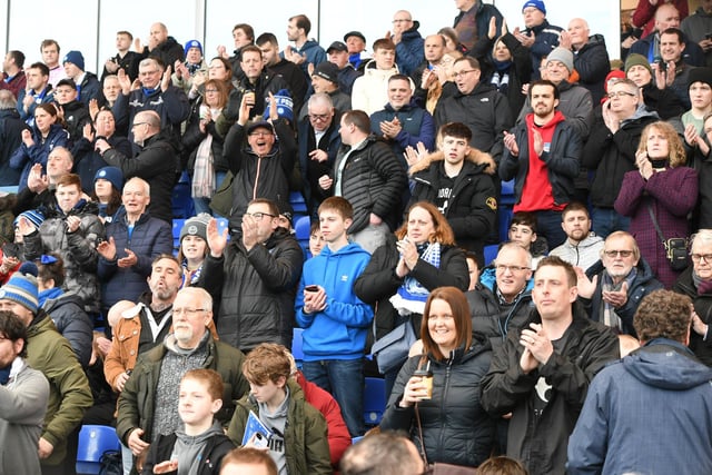 Peterborough United fans watch the defeat to Wigan Athletic.