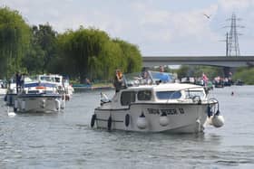 The Peterborough Yacht Club Coronation Flotilla makes its way past the Embankment