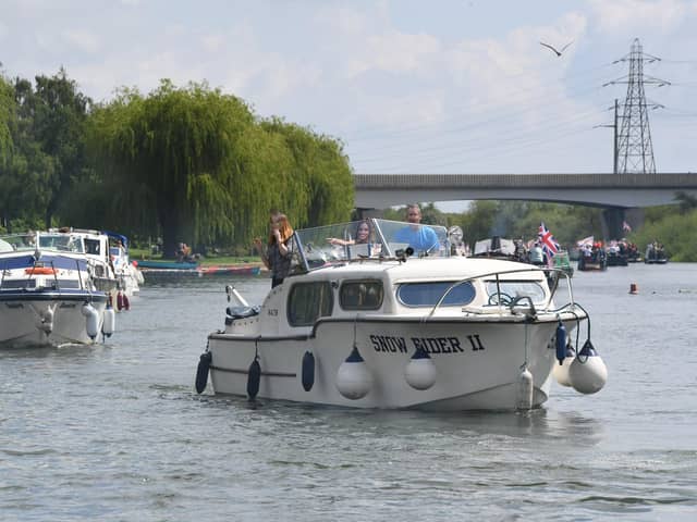 The Peterborough Yacht Club Coronation Flotilla makes its way past the Embankment