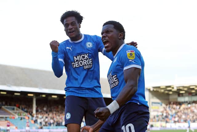 Nathanael Ogbeta (left) celebrates a Posh goal with Ephron Mason-Clark last season. Photo: Joe Dent/theposh.com.