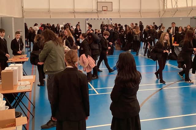 Students gathering in the hall to participate in the fundraising activities