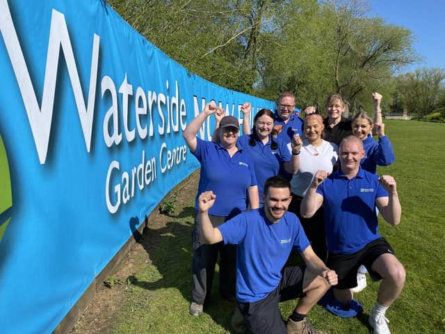 Staff at the Waterside Garden Centre in Baston, near Peterborough, celebrate the reopening of the centre after severe flooding.