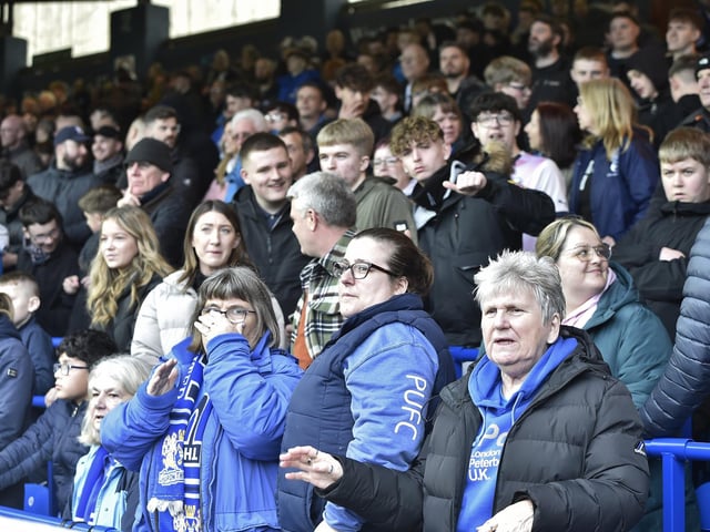 Peterborough United fans watch as their side slip to defeat against Blackpool.