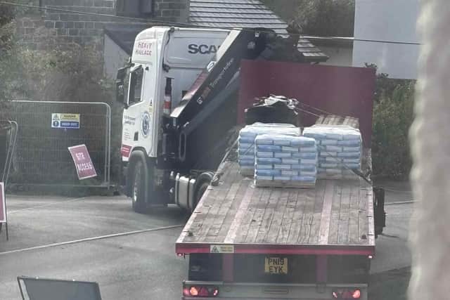A huge lorry turns into entrance of the construction site in Eye