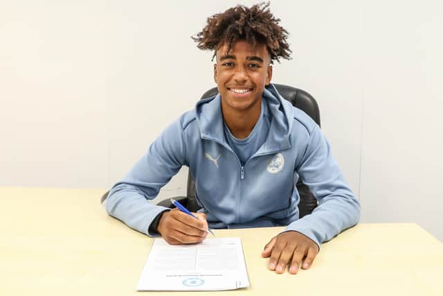 James Dornelly signing his new Peterborough United contract. Photo: Joe Dent.