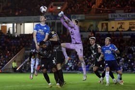 Kell Watts of Peterborough United challenges for the ball against Milton Keynes Dons. Photo: Joe Dent/theposh.com.