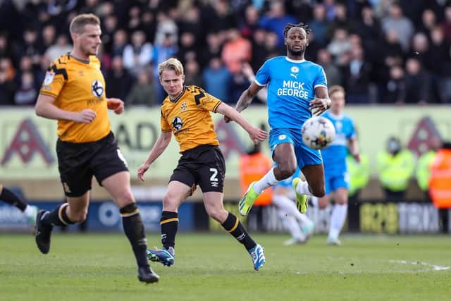 Posh striker Ricky-Jade Jones in action with Liam Bennett (centre) of Cambridge United at the Abbey Stadium last season. Photo Joe Dent/theposh.com.