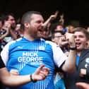 A Peterborough United fan celebrates after their first goal at last season.