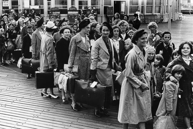 Evacuees line up for the boats. The News PP300