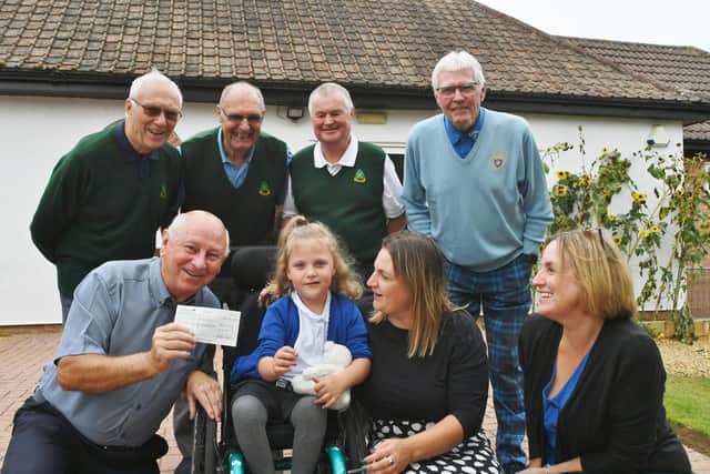 Tree Iron Society members Pete Waters, Patrick Garner, Rod Brailsford, Roy Chowings and John McCallum presents a cheque for £500 to Louise Evans, Lauren Smith and Ava Lucas (7) from Little Miracles.