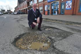  Cllr Andy Coles with potholes at shops at Sugar Way, Woodston