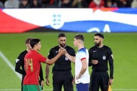 England captain Ronnie Edwards at the pre-match coin toss with his Portugal counterpart at stadium:mk. Photo: Joe Dent/theposh.com.