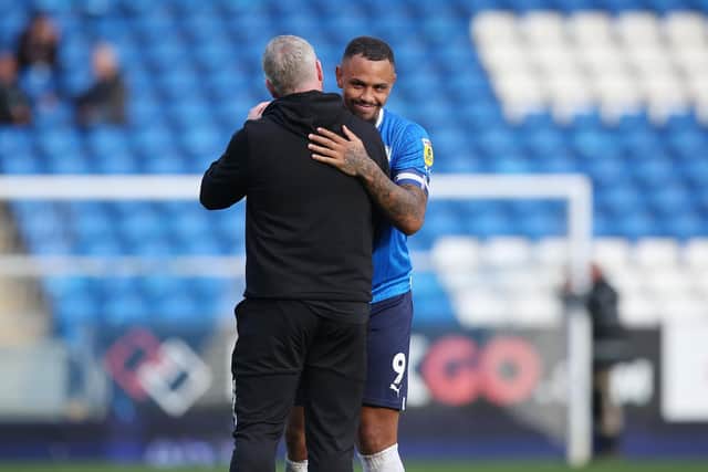 Jonson Clarke-Harris of Peterborough United is congratulated by manager Grant McCann. Photo: Joe Dent/JMP