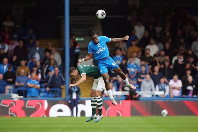 Peter Kioso beats Craig Forsyth of Derby County in the air. Photo: Joe Dent.