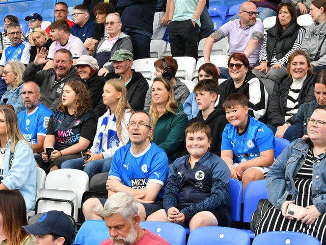 Peterborough United fans watch as their side are beaten at home to Wrexham.