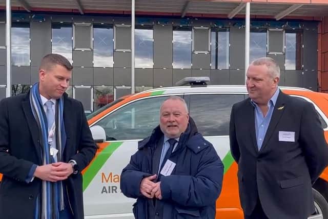 Cllr Wayne Fitzgerald (centre) at the new Magpas Air Ambulance HQ, with Daryl Brown, CEO of Magpas (left) and Phil Hayes (right) who recovered from life-changing injuries thanks to the charity.