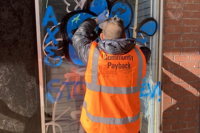 The community payback team clearing graffiti in the city centre