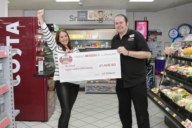 Petya Dinova collecting her prize from Store Manager James McLean at SPAR Welland Road, Peterborough.