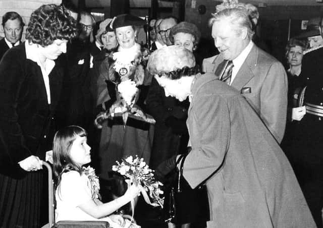 Lorraine Cherry, from Werrington, presents a bouquet to The Queen during a visit to Peterborough in 1978