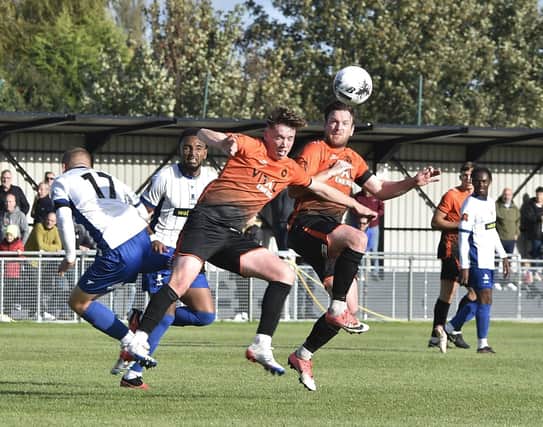 Debutant Oisin Gallagher (orange, left) in action for Peterborough Sports (orange) v Banbury. Photo: David Lowndes.