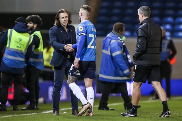 Wycombe manager Gareth Ainsworth shakes hands with Posh star Joe Ward after a match at London Road on New Year's Day. Photo: Joe Dent/theposh.com.