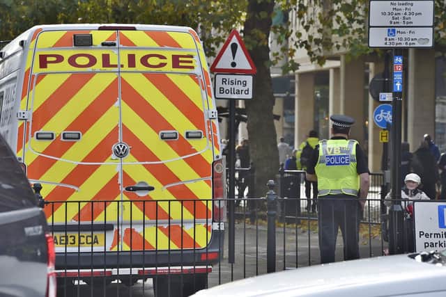 Police and football fans in the city centre before the Cambridge game
