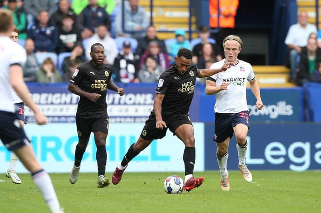 Nathan Thompson of Peterborough United is tracked by Kyle Dempsey of Bolton Wanderers. Photo: Joe Dent/theposh.com.