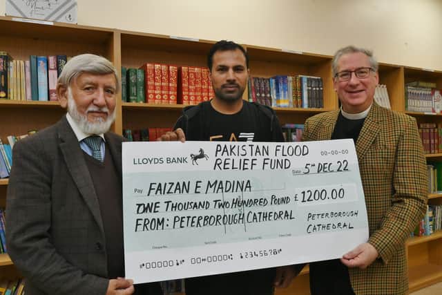 Tim Alban-Jones (right), vice dean of Peterborough Cathedral, presents a cheque for £1,200 to Abdul Choudhuri (left), chairman of the Faizan-e-Madina Mosque, and vice chairman Zeesham Ahmed (centre), for the Pakistan Floods Appeal