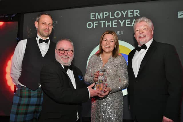 Peterborough Telegraph Business Excellence Awards 2022.  Winners of the Employer of the Year Connections Legal Management's Laura Wilson, with Cllr Wayne Fitzgerald, leader of award sponsors Peterborough City Council, second left, and guest speaker Simon Weston, right.