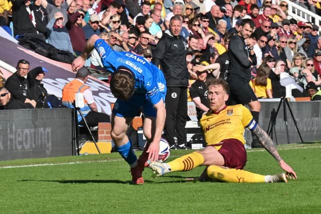 Posh substitute Cian Hayes takes a tumble against Cobblers. Photo David Lowndes.