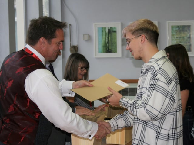 Cian Lowrey receiving his results from Bourne Grammar School headteacher Alastair Anderson