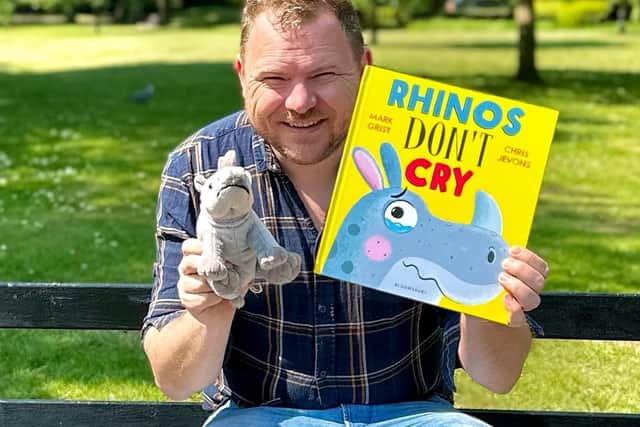 Mark with his new book, Rhinos don't cry. Photo: Mark Grist