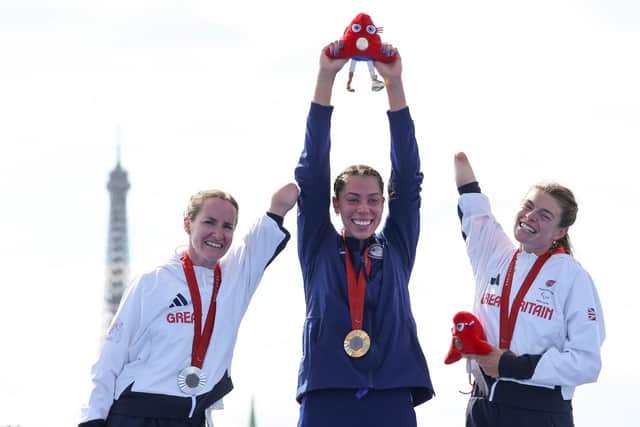 Left-to-right Clare Cashman, Grace Norman and Lauren Steadman on the podium after their Paralympic triathlon race in Paris. (Photo by Tasos Katopodis/Getty Images).