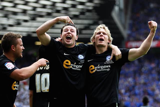 Lee Tomlin celebrates with Craig Mackail-Smith during the League One Play-Off Final in 2011. Photo: Dean Mouhtaropoulos. Getty Images.