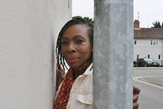 Carmen Murray with the lamppost beside her house.