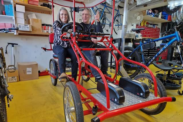 Graham Hicks and his long-time friend and deaf-blind assistant, Linda Hindmarch, on the four-seater Surrey bike which he built himself from scratch.