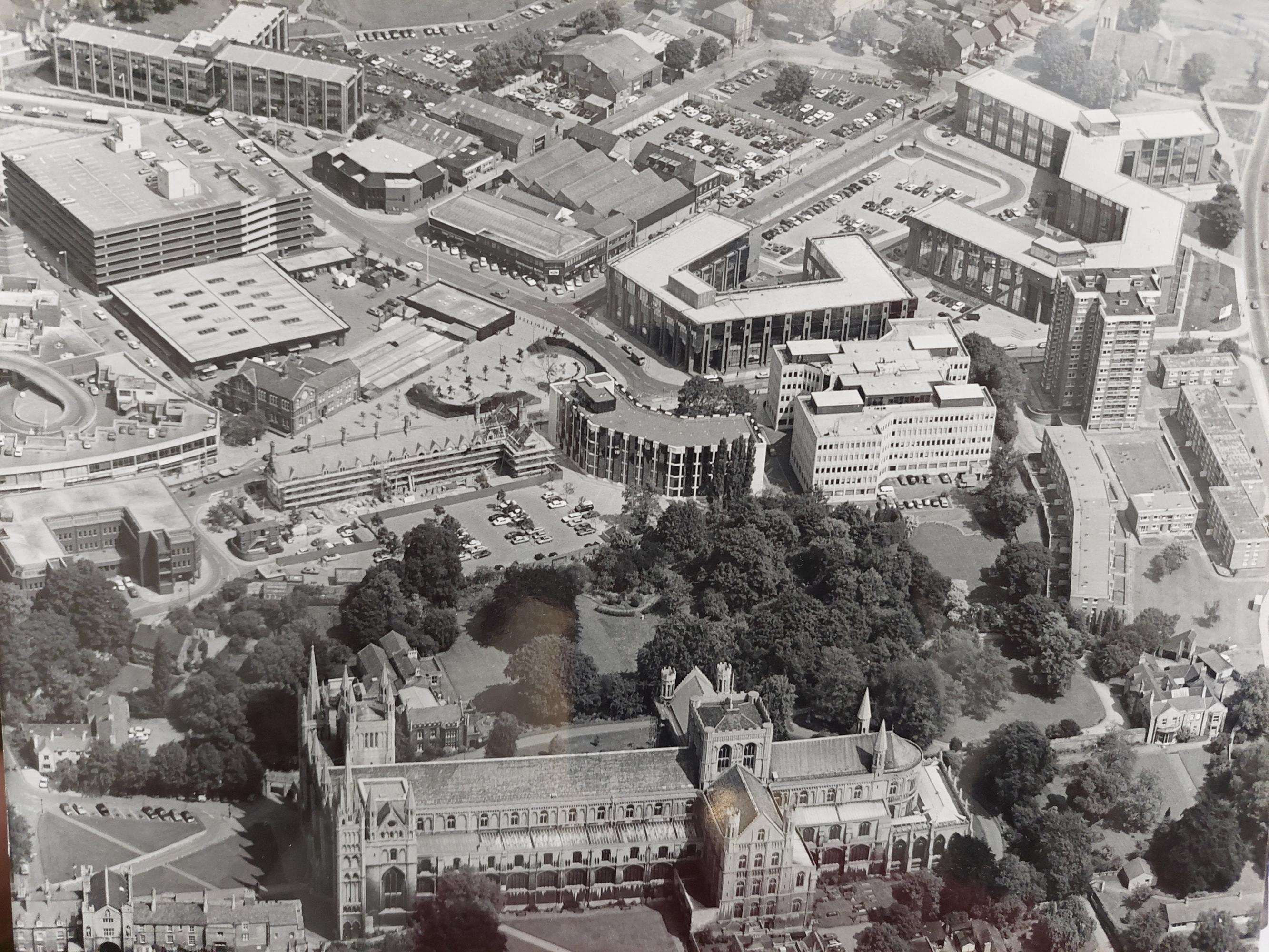 An aerial shot of Peterborough Cathedral - with the Passport Office, 12-storey Cumberland House and the old market and multi-storey car park visible.