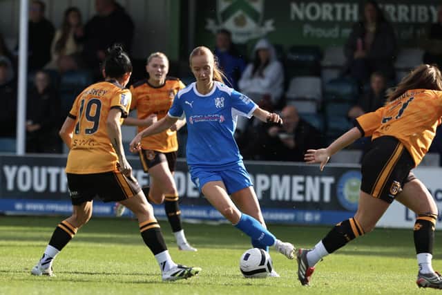 Lauren Wilshaw of Posh Women is surrounded by Hull City players. Photo Darren Wiles.